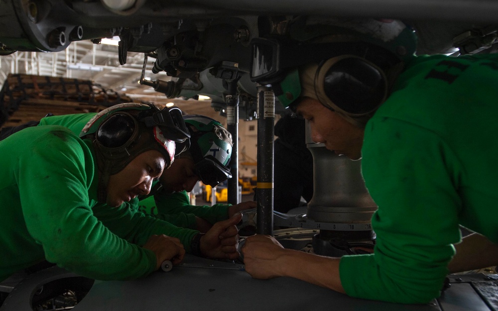 Sailor Removes Screws From Aircraft