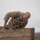 Ivy Week 2022 Mabry Mile: One more push A U.S. Army soldier in OCP (Operational Camouflage Pattern) uniform is climbing over a wooden wall obstacle, likely part of a military obstacle course or physical fitness test. The soldier is visibly exerting significant effort, with a strained facial expression. Patches on the uniform include a U.S. flag and what appears to be a 4th Infantry Division patch.