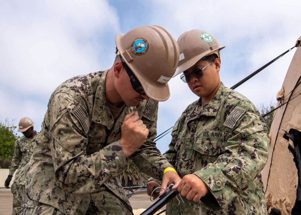 Sailors assigned to Assault Craft Unit One construct tents