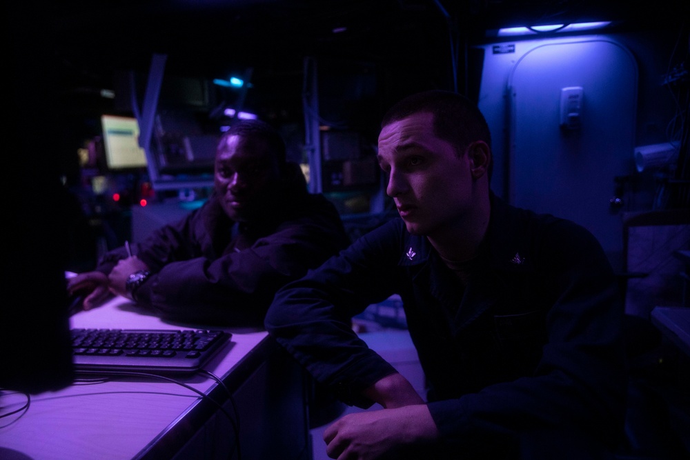 Sailors Stand Watch in Combat Information Center Aboard USS Ralph Johnson (DDG 114)