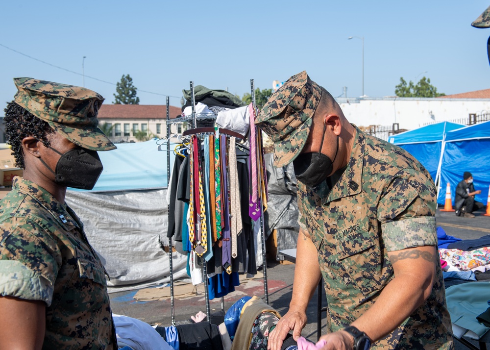 Sailors and Marines assigned to USS Portland volunteer