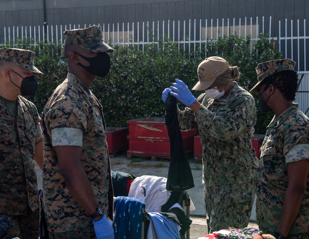 Sailors and Marines assigned to USS Portland volunteer