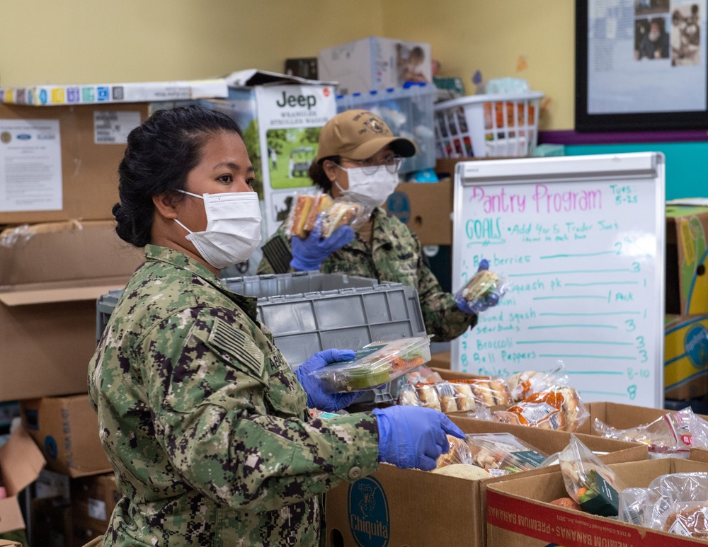 Sailors and Marines assigned to USS Portland volunteer