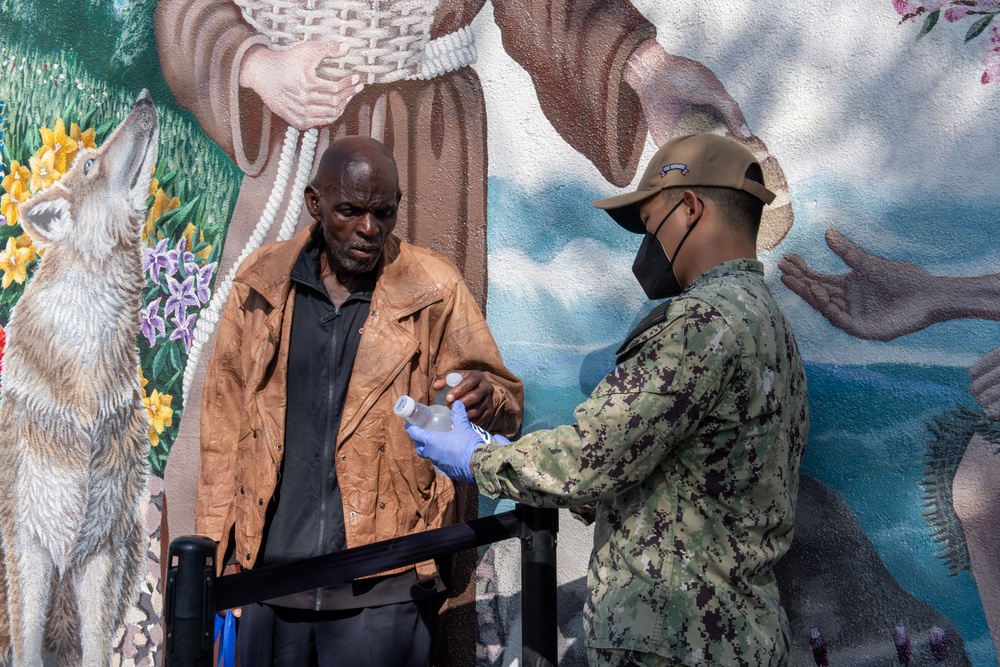 Sailors and Marines assigned to USS Portland volunteer