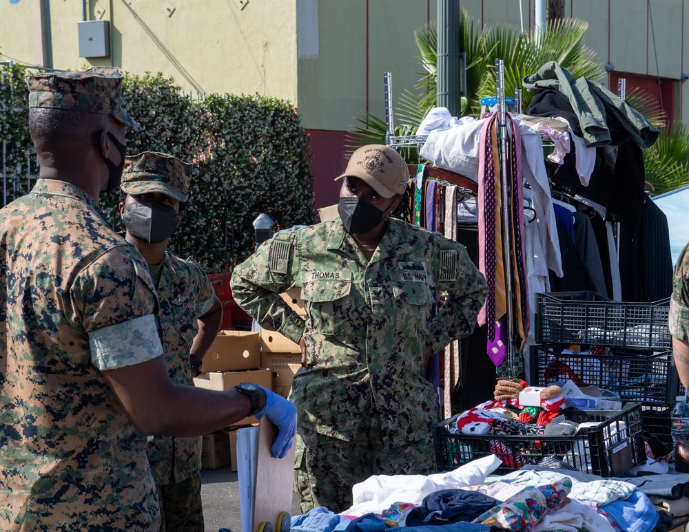 Sailors and Marines assigned to USS Portland volunteer