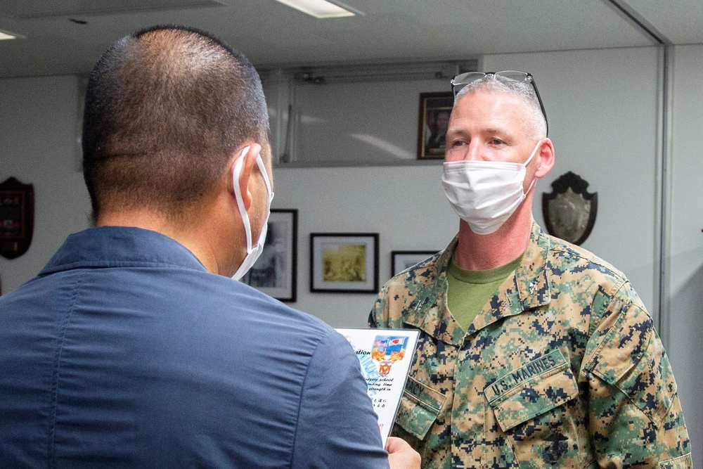 OKINAWAN NURSERY SCHOOL PRINCIPAL VISITS CAMP SCHWAB COMMANDER, BRINGS GIFTS