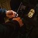 An ICE Enforcement and Removal Operations deportation officer prepares his protective equipment prior to conducting an arrest
