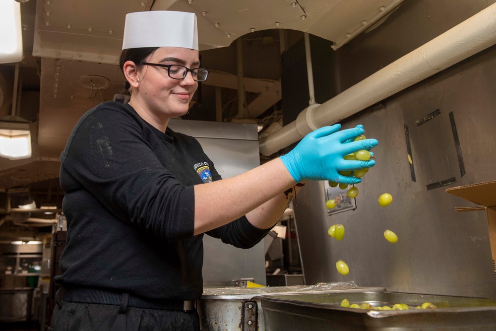 Sailor Rinses Off Grapes