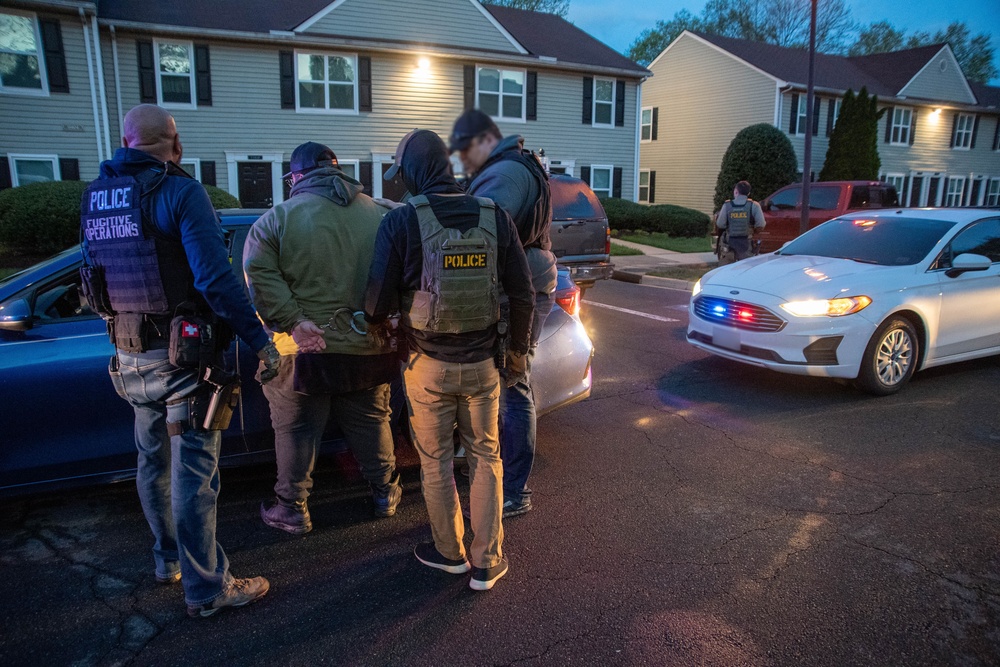 ICE Enforcement and Removal Operations (ERO) deportation officers effect an arrest during a vehicle stop
