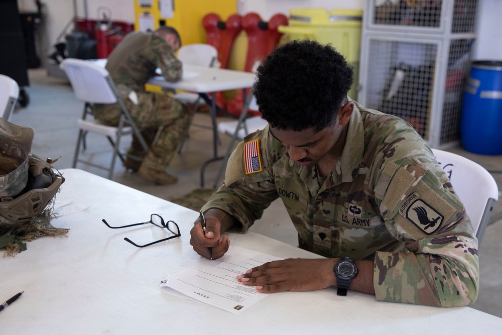 Competitors take a break from physical activities to complete the exam during SETAF-AF Best Warrior and Squad Competition