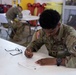 Competitors take a break from physical activities to complete the exam during SETAF-AF Best Warrior and Squad Competition