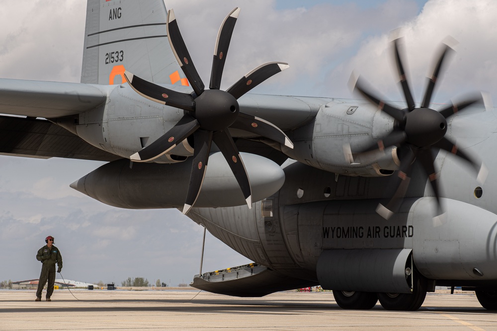 A C-130 from the 153d Airlift Wing equipped with USDA Forest Service MAFFS II (Modular Airborne Fire Fighting System)