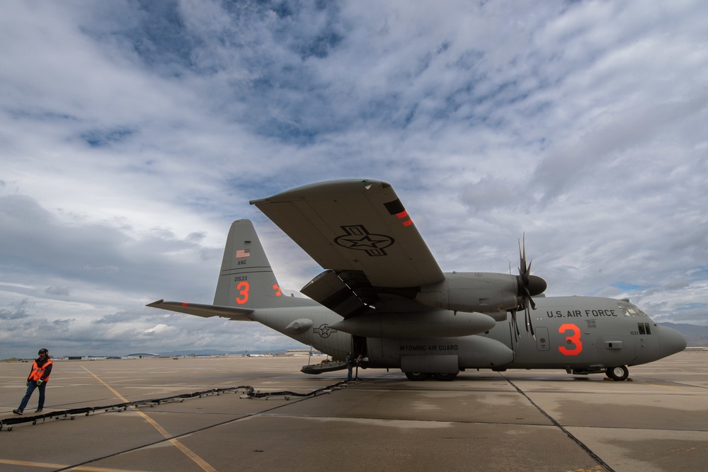 A C-130 from the 153d Airlift Wing equipped with USDA Forest Service MAFFS II (Modular Airborne Fire Fighting System)