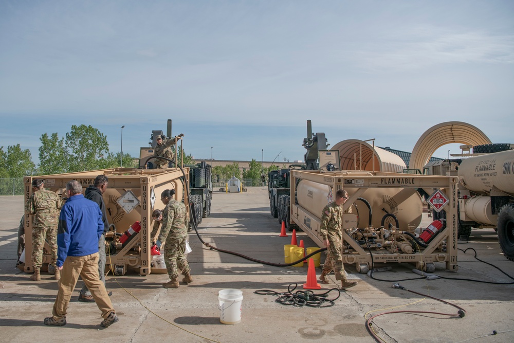 Michigan National Guard perform a fuel line flushing and recirculation procedure on a tank rack module