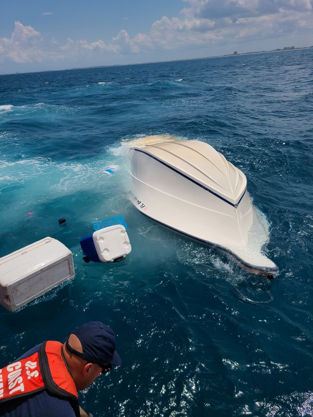 Coast Guard rescues 2 people from a capsized vessel near Fort Pierce Inlet