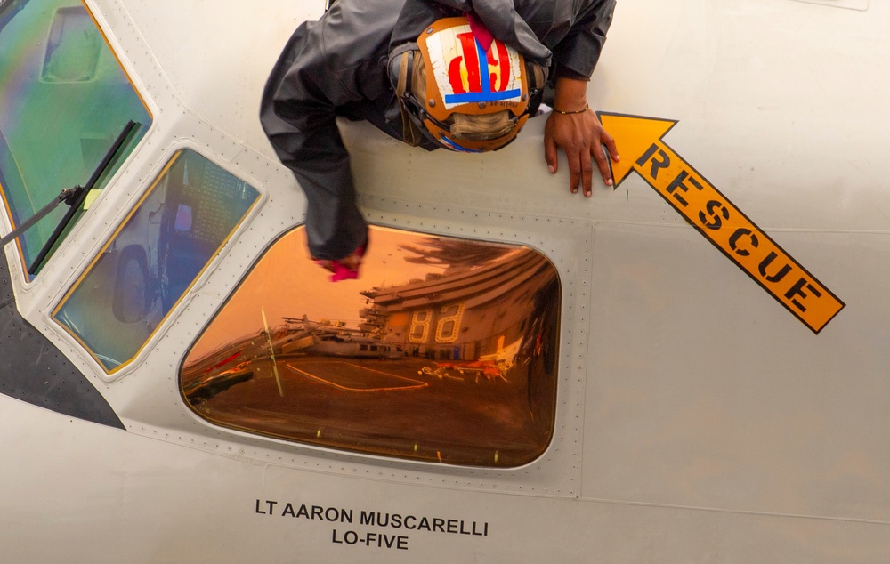 Sailor Cleans Window On An E-2C Hawkeye