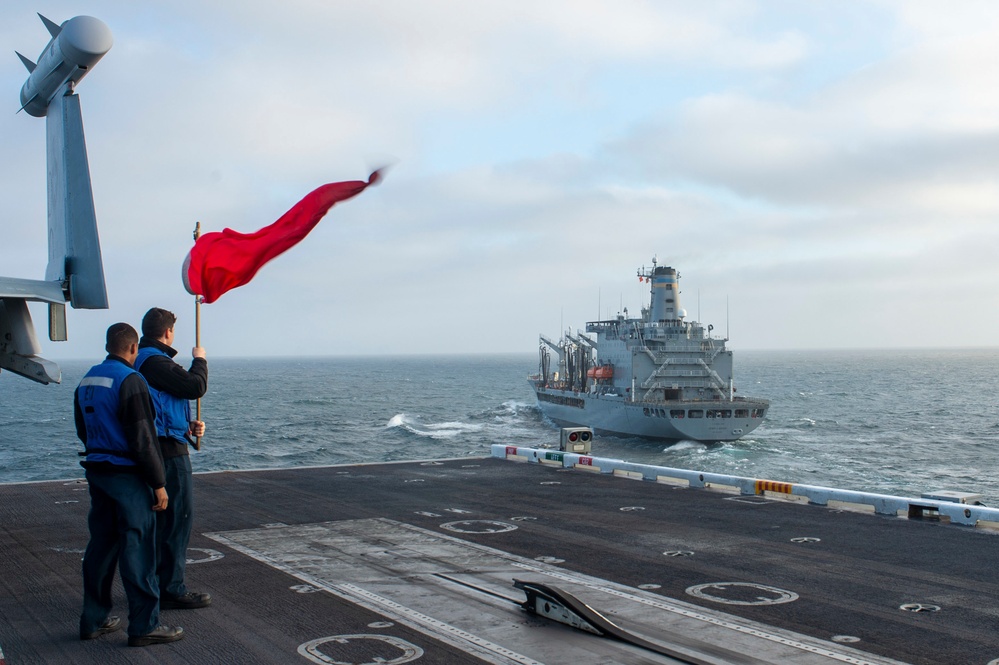 Sailors Signal USNS Henry J. Kaiser