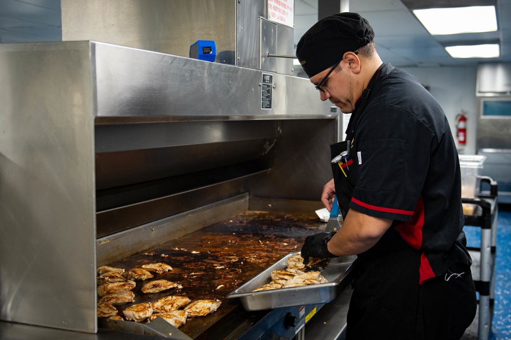 USS Carl Vinson (CVN 70) Sailor Prepares Dinner