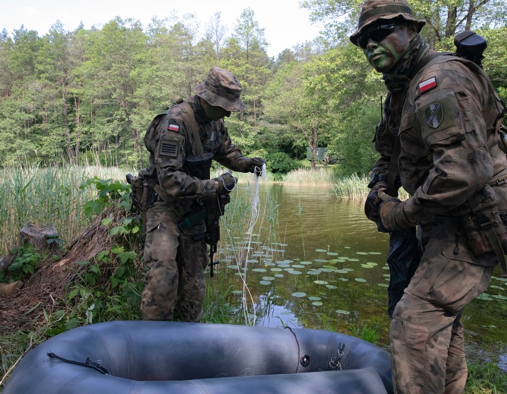 eFP Battle Group Poland Troops Train Together During Wet Gap Crossing Exercise