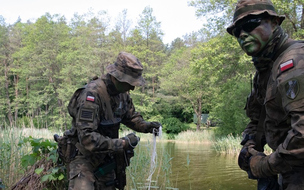 eFP Battle Group Poland Troops Train Together During Wet Gap Crossing Exercise