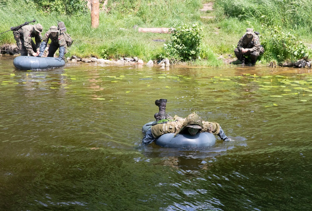 eFP Battle Group Poland Troops Train Together During Wet Gap Crossing Exercise