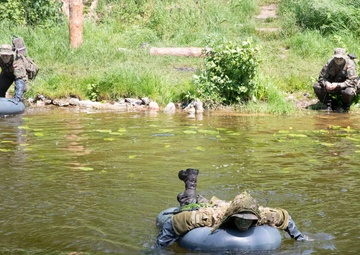 eFP Battle Group Poland Troops Train Together During Wet Gap Crossing Exercise
