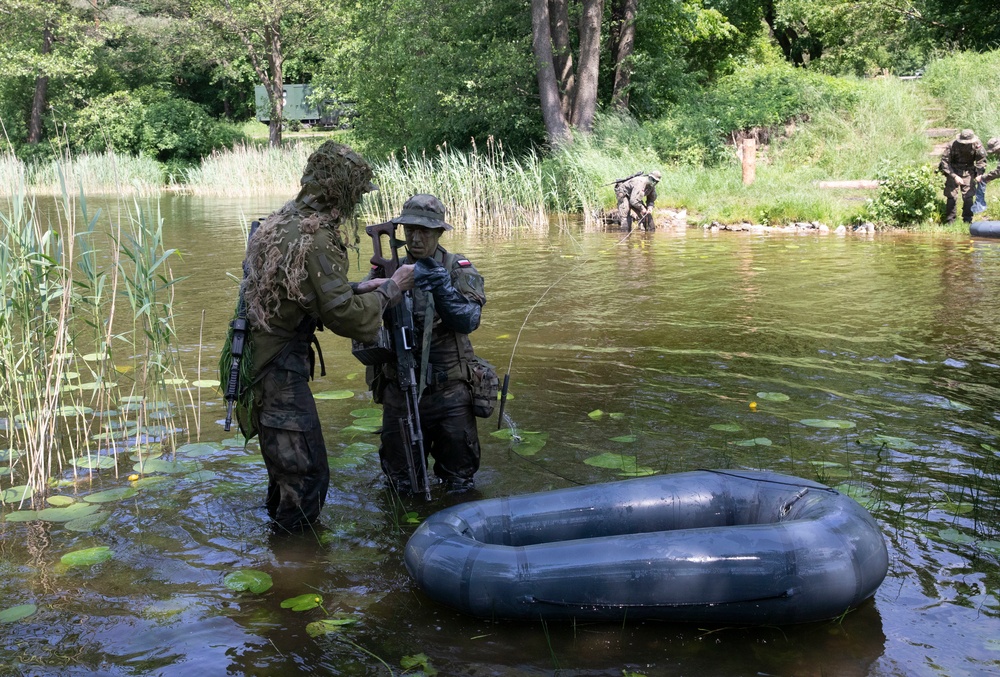 eFP Battle Group Poland Troops Train Together During Wet Gap Crossing Exercise