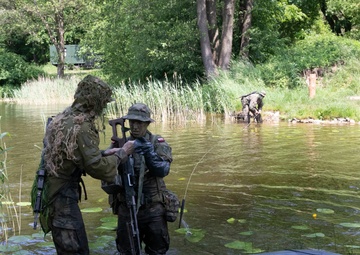 eFP Battle Group Poland Troops Train Together During Wet Gap Crossing Exercise