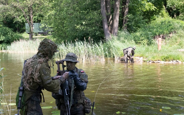 eFP Battle Group Poland Troops Train Together During Wet Gap Crossing Exercise