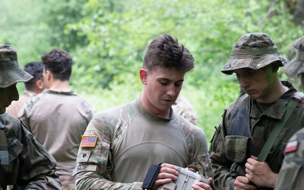 eFP Battle Group Poland Troops Train Together During Wet Gap Crossing Exercise