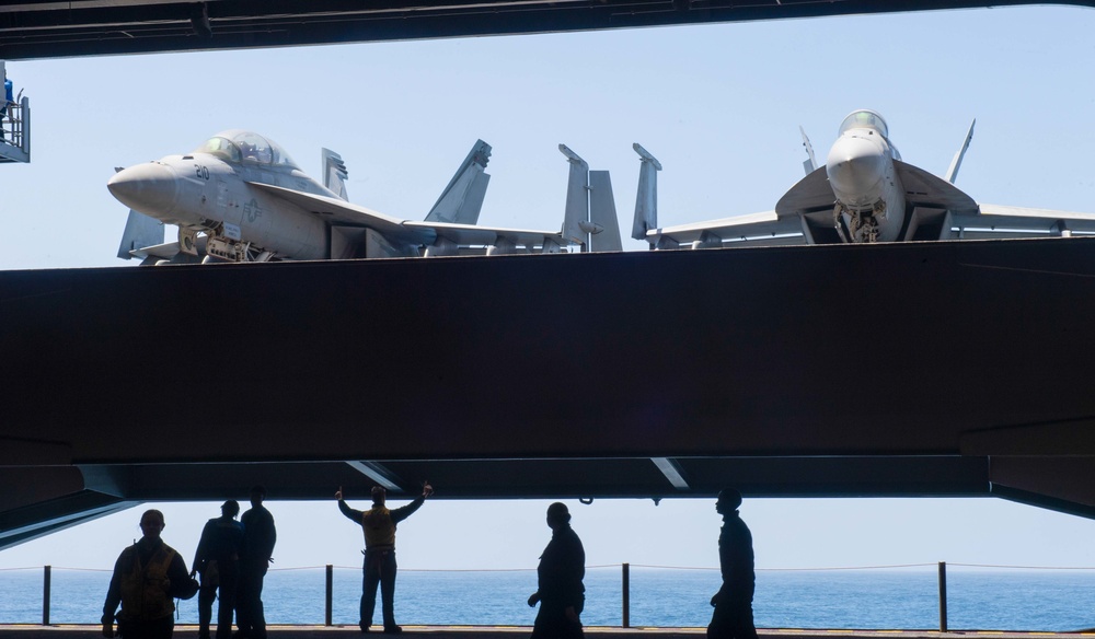 F/A-18E Super Hornets Are Elevated Out Of Hangar Bay