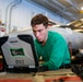 Abraham Lincoln Sailor conducts aircraft maintenance