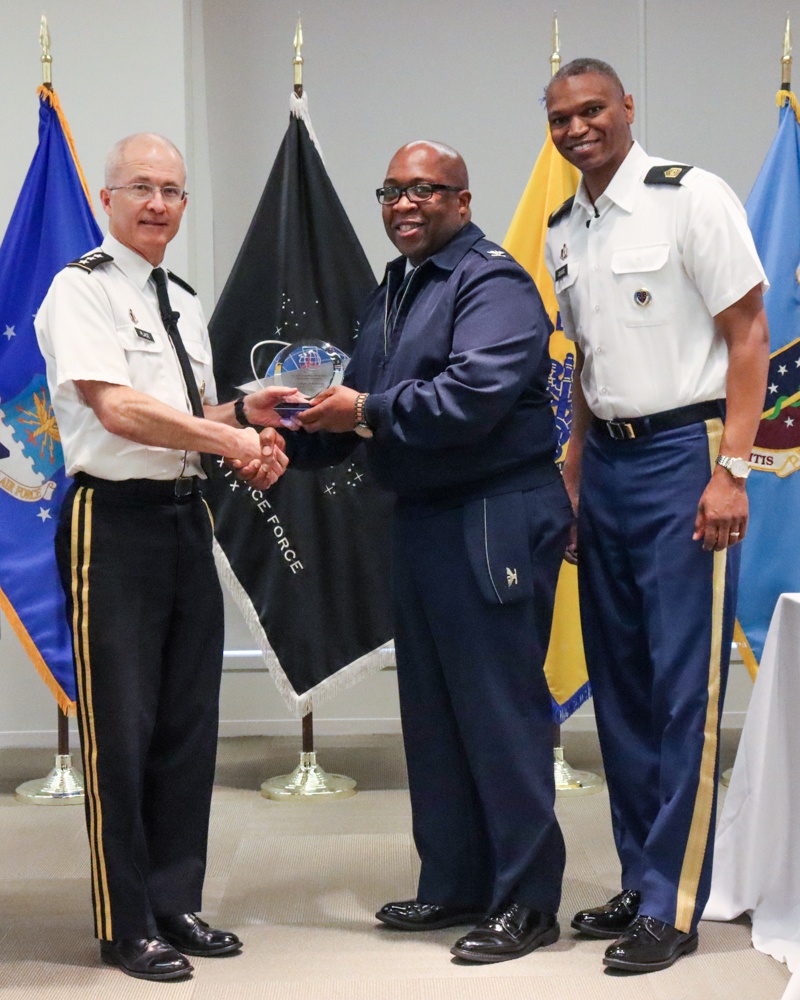 Lieutenant General Ronald J. Place and Command Sgt. Maj. Michael L. Gragg presenting an award with Colonel Patrick Kennedy.