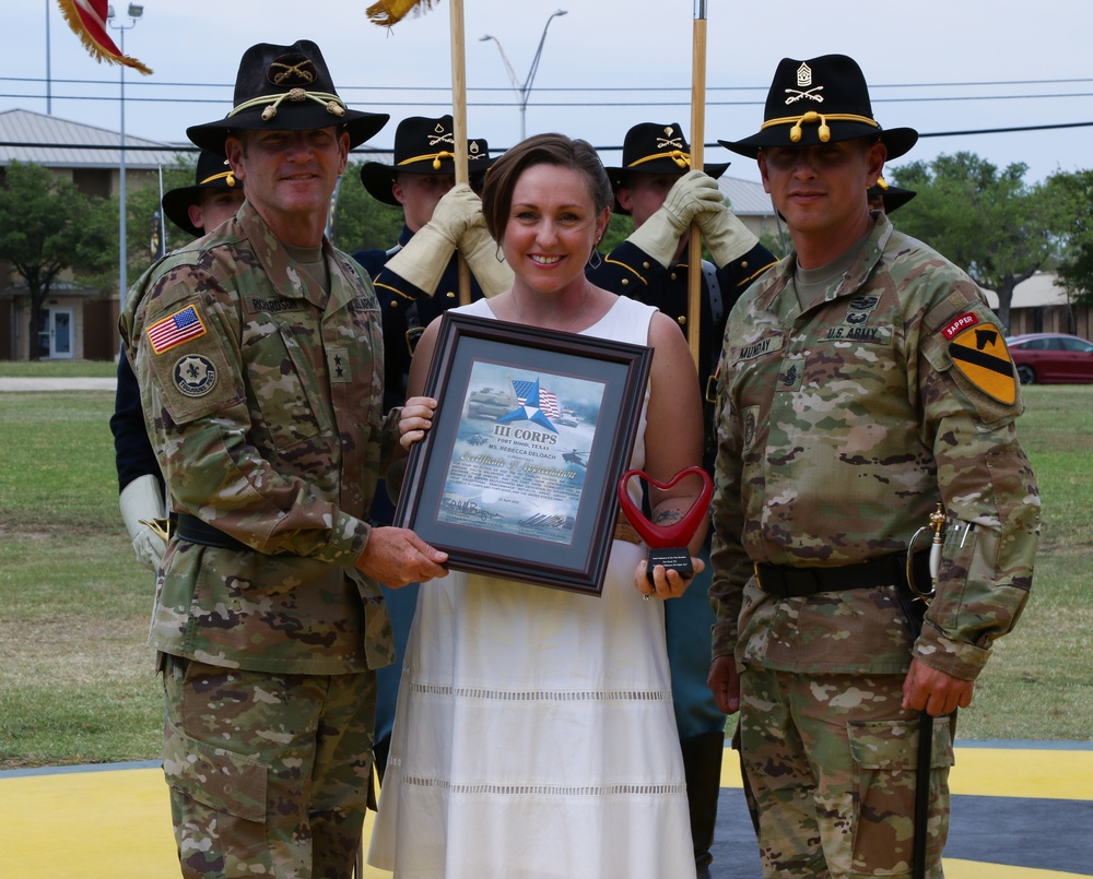 Mrs. Rebecca Deloach receives the 'Heart' Trophy during a Volunteer of the Year Ceremony.