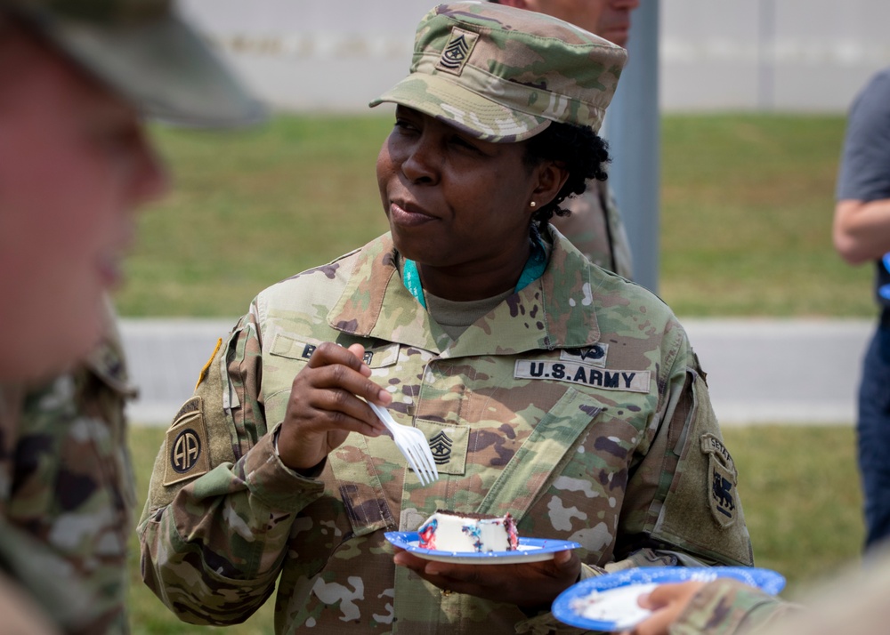 SGM Sue-Ellyn Baker enjoys a slice of cake during commemoration