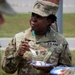 SGM Sue-Ellyn Baker enjoys a slice of cake during commemoration