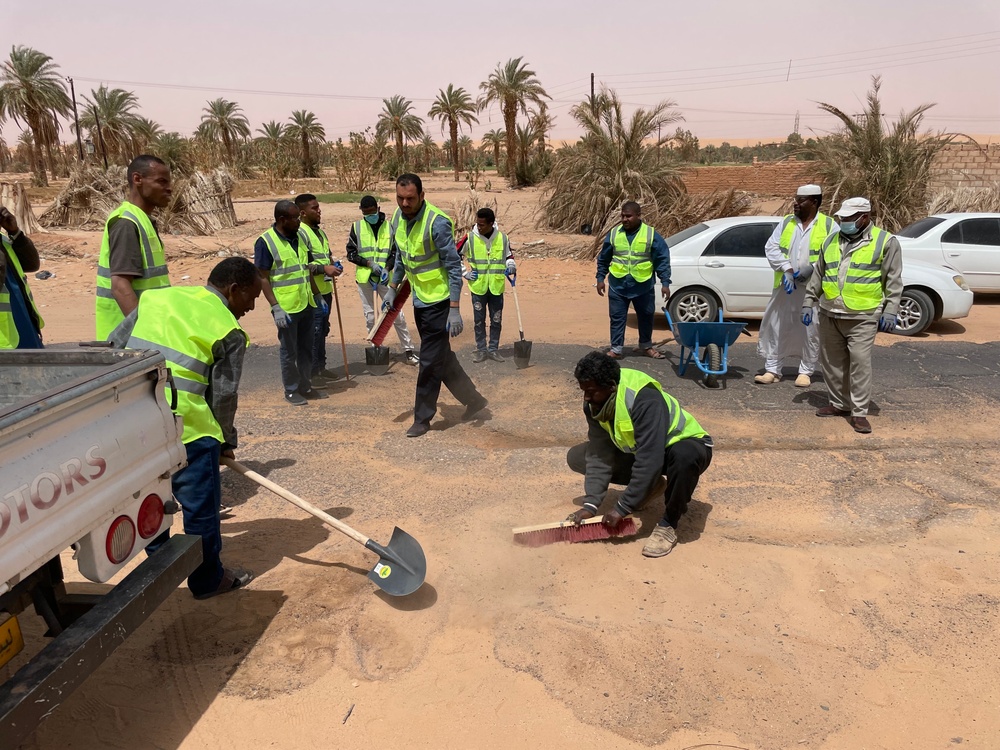 USAID trained volunteers repair road in Libya