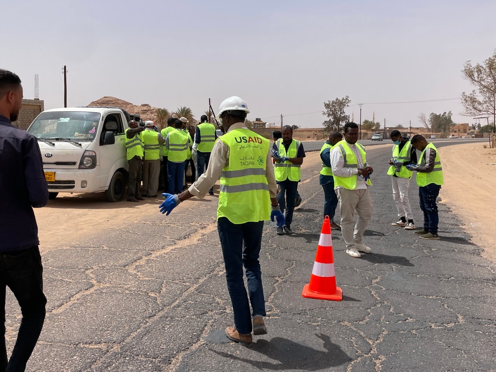 USAID trained volunteers repair road in Libya