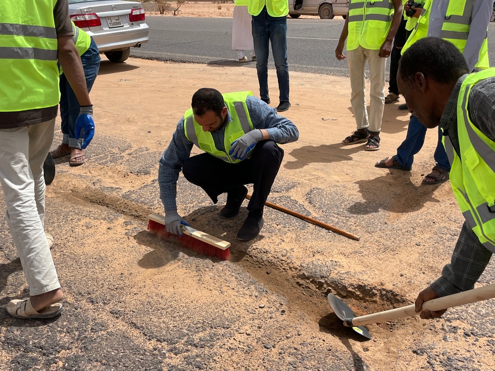 USAID trained volunteers repair road in Libya