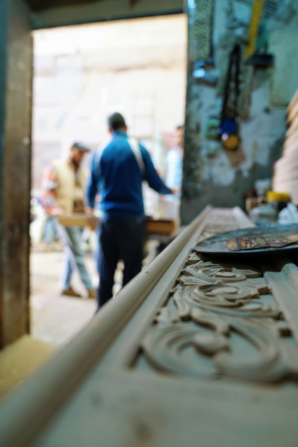 Members of a woodworking cooperative in Marrakech work outside their shop