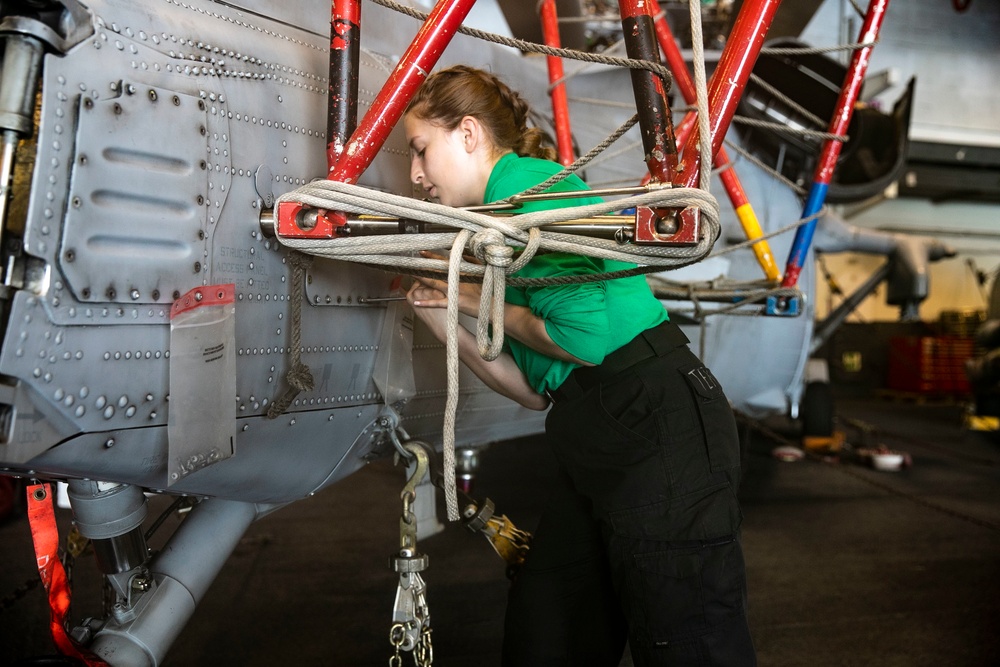 USS George H.W. Bush Sailor Preforms Maintenance