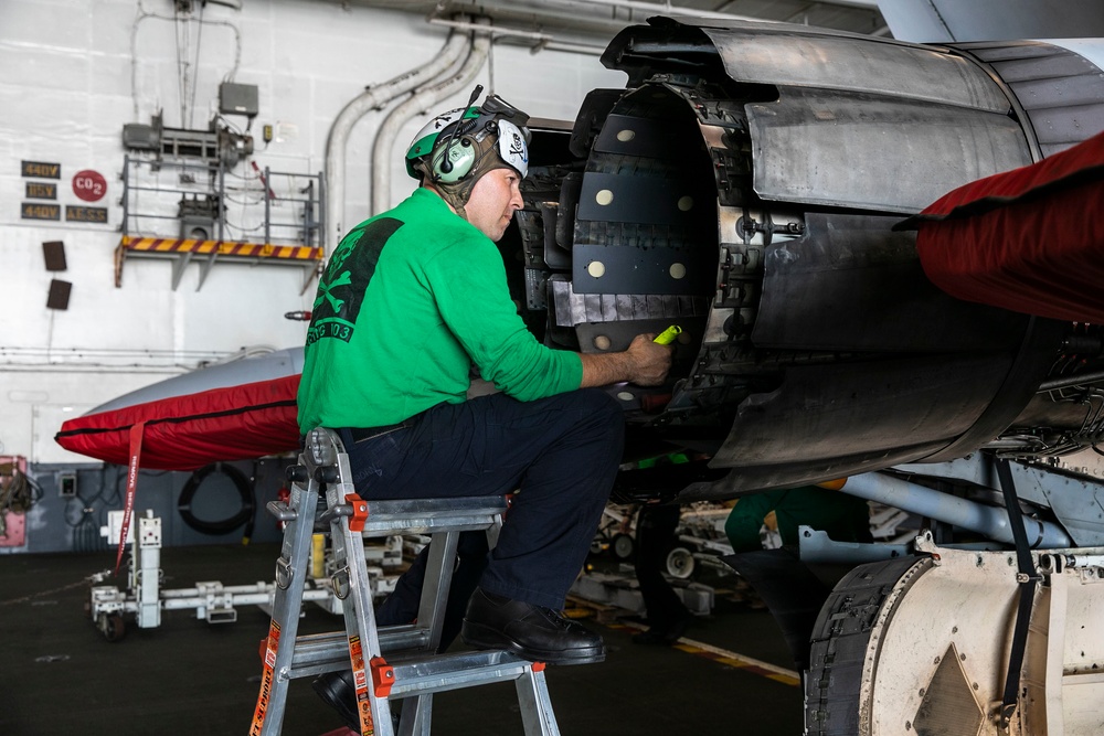 Sailor Preforms Maintenance on Aircraft