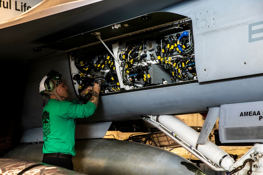 Sailor Preforms Maintenance on Aircraft