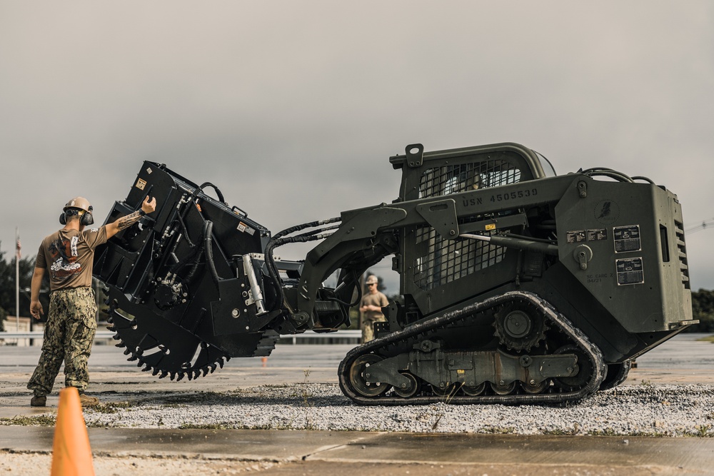 U.S. Marines work with Airmen and Navy Seebees during a joint airfield damage repair exercise