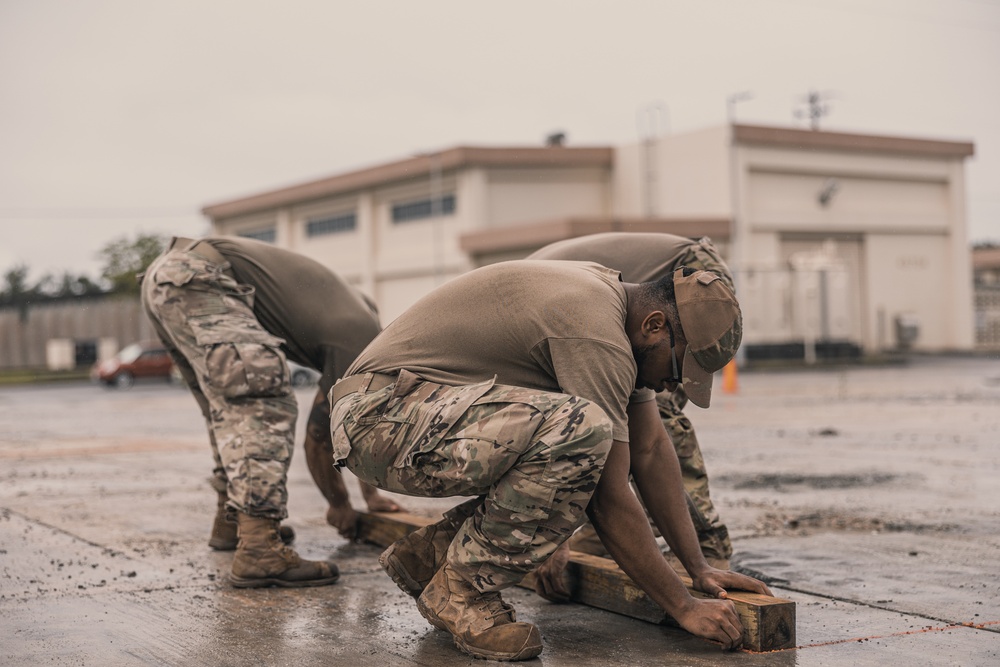 U.S. Marines work with Airmen and Navy Seebees during a joint airfield damage repair exercise