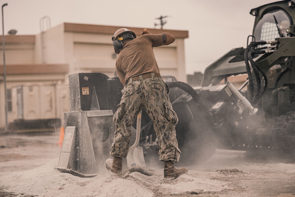 U.S. Marines work with Airmen and Navy Seebees during a joint airfield damage repair exercise