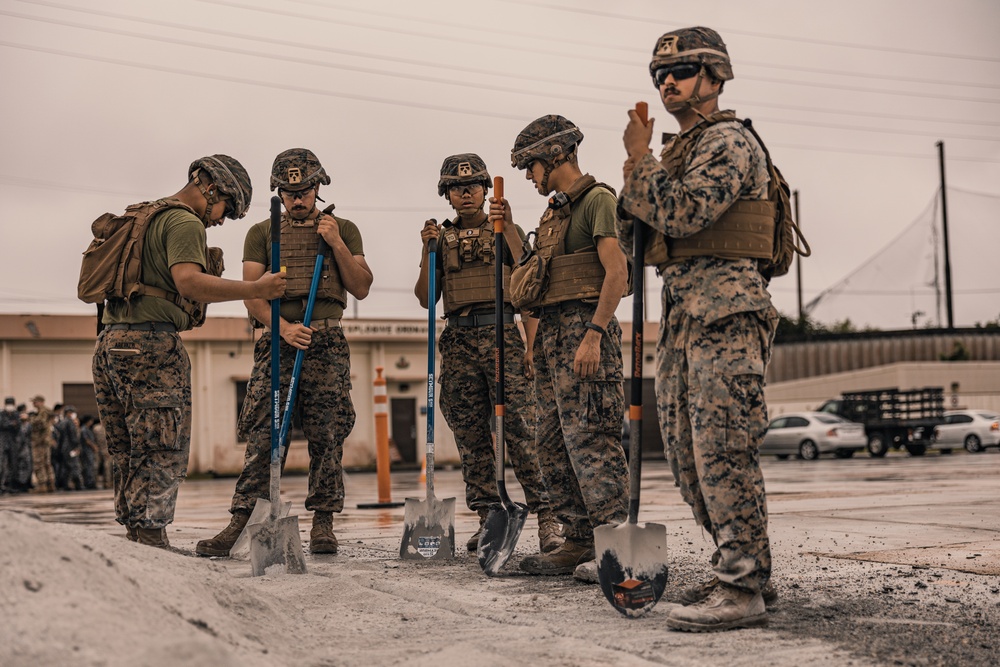 U.S. Marines work with Airmen and Navy Seebees during a joint airfield damage repair exercise