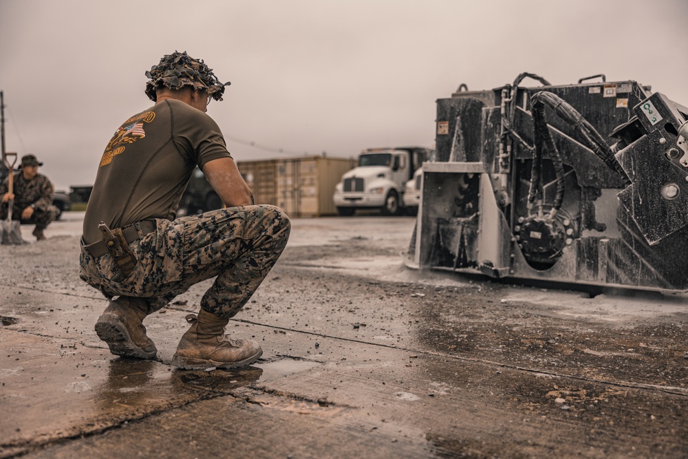 U.S. Marines work with Airmen and Navy Seebees during a joint airfield damage repair exercise