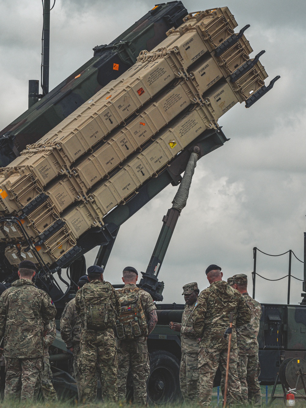 Members of Great Britain's Sky Saber Team stand under Patriot Interceptors