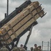 Members of Great Britain's Sky Saber Team stand under Patriot Interceptors